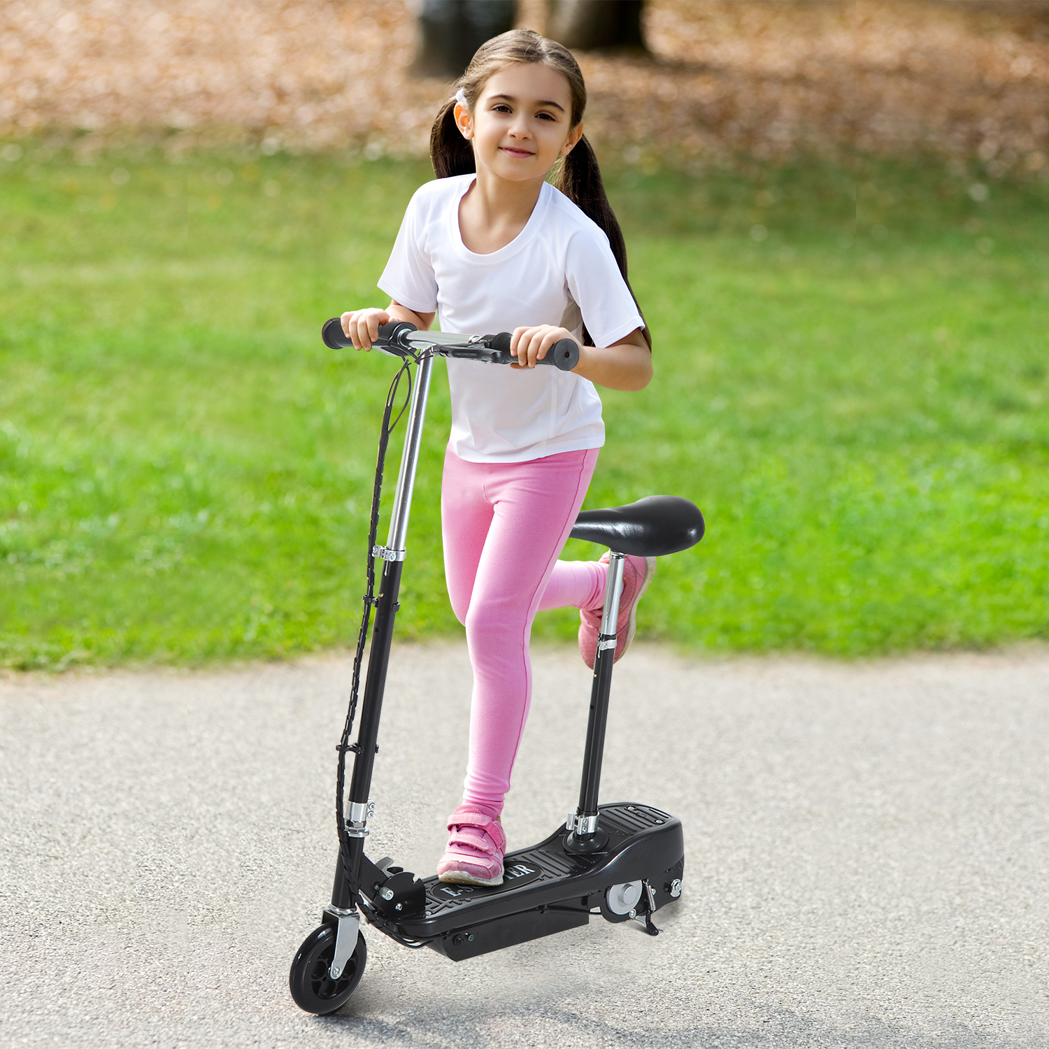Cute young girl playing on a scooter
